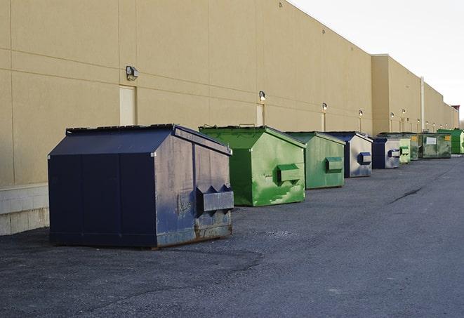 construction waste bins waiting to be picked up by a waste management company in Dennis Port, MA